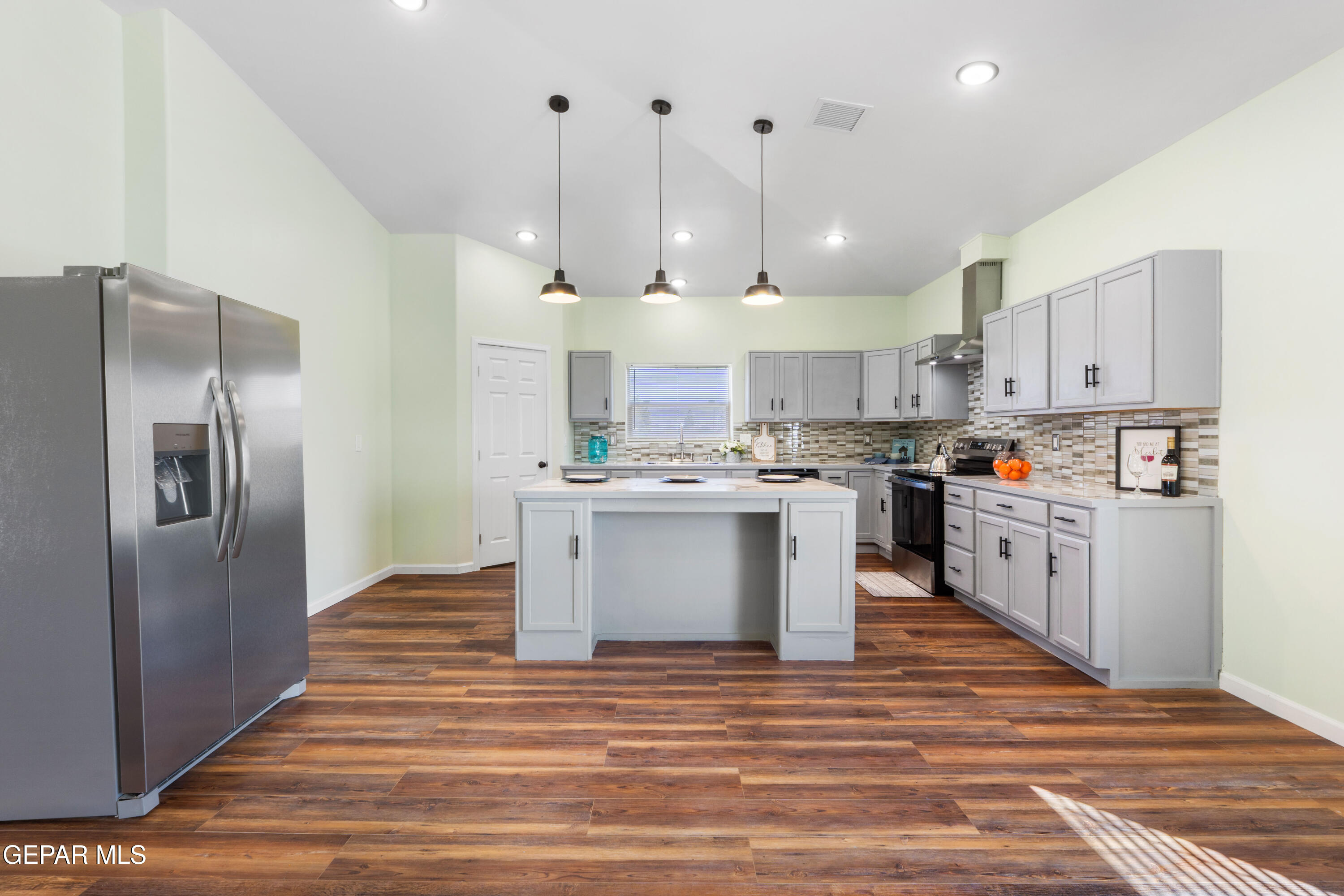 646 Snow Road, Unit 2 Las Cruces, NM 88005 - Photo 16 of 41 a kitchen with stainless steel appliances kitchen island a refrigerator sink and cabinets