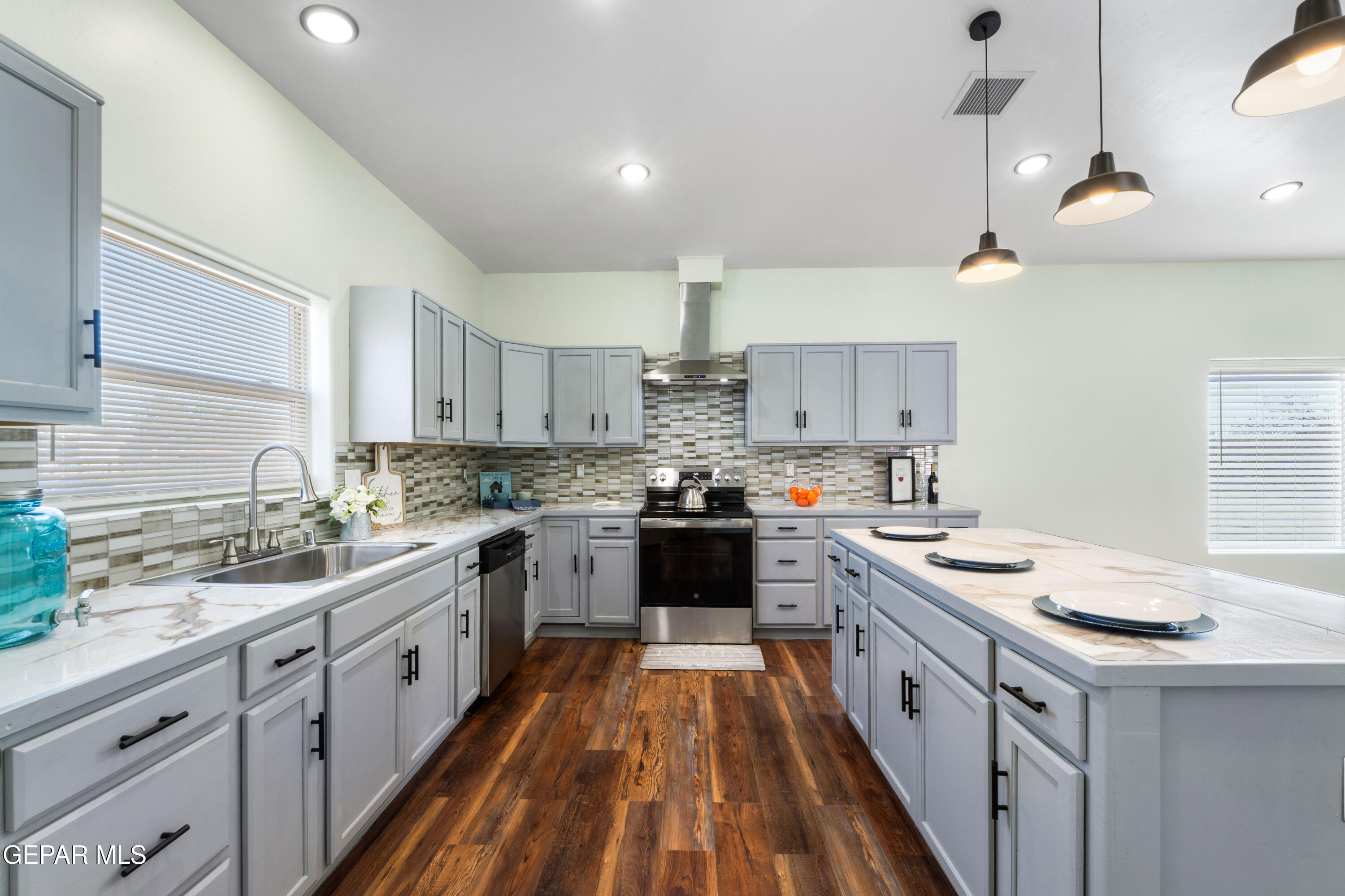 646 Snow Road, Unit 2 Las Cruces, NM 88005 - Photo 19 of 41 a kitchen with a sink stove cabinets and wooden floor