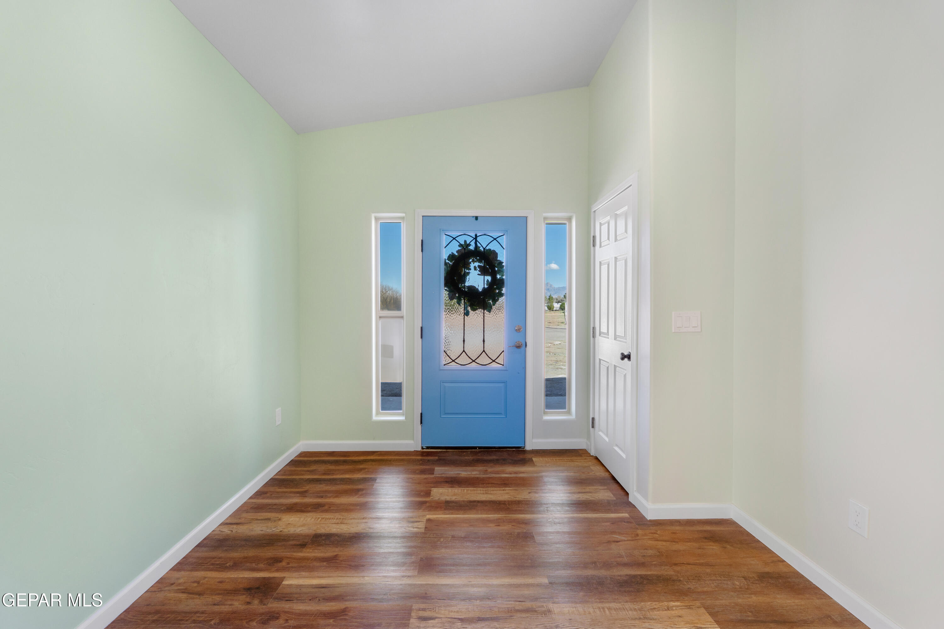 646 Snow Road, Unit 2 Las Cruces, NM 88005 - Photo 6 of 41 a view of a hallway with wooden floor and closet