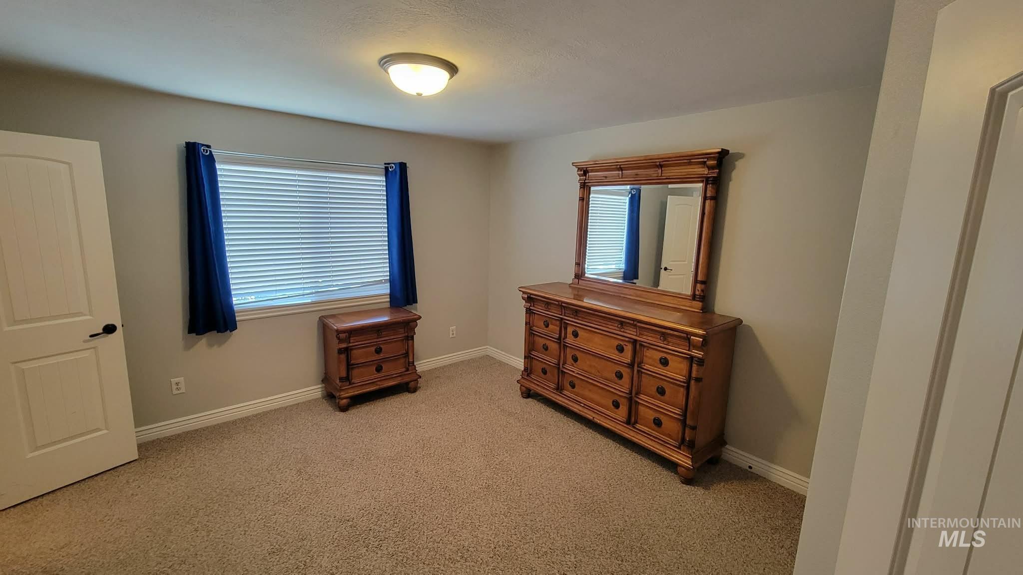 470 Sunflower Road Rexburg, ID 83440 - Photo 13 of 16 Bedroom with light colored carpet and baseboards