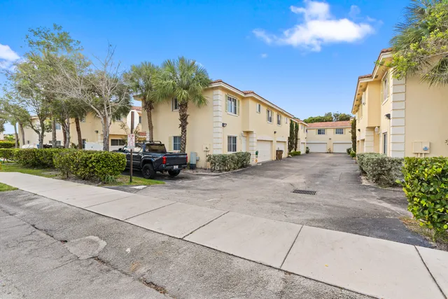 a view of a car park in front of a house