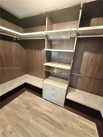 a view of walk in closet with empty racks