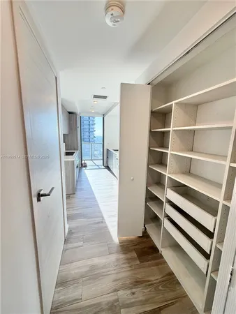 a view of a hallway view with wooden floor and staircase