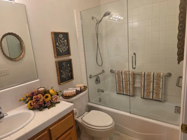a bathroom with a sink toilet and shower