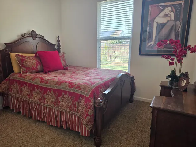 a bedroom with a bed and a window