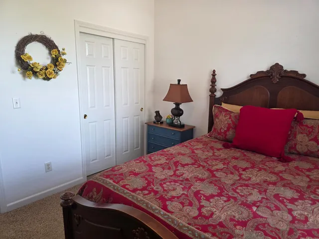 a bedroom with a bed and a cabinets