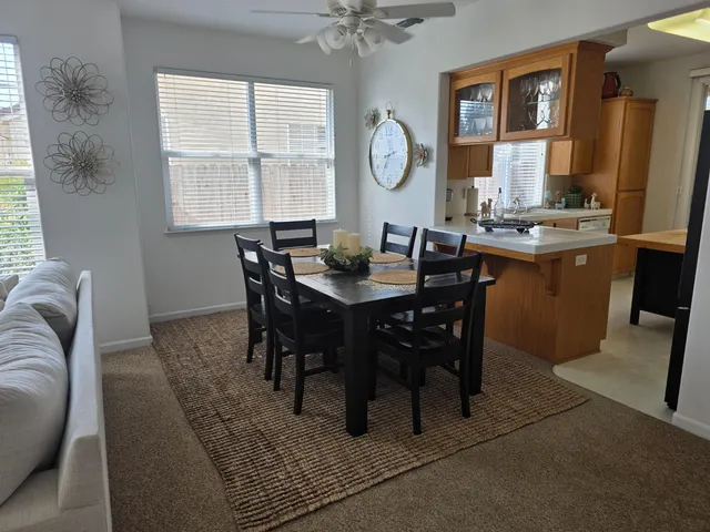 a view of a dining room with furniture and window