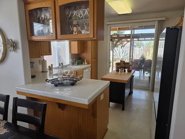 a view of a dining room with furniture a chandelier and wooden floor