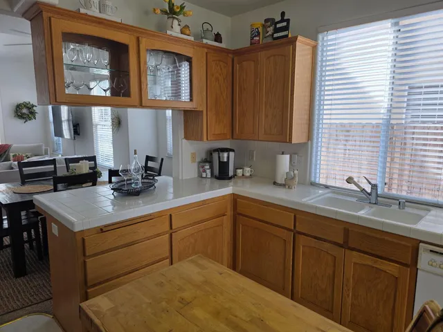 a kitchen with a sink cabinets and a window