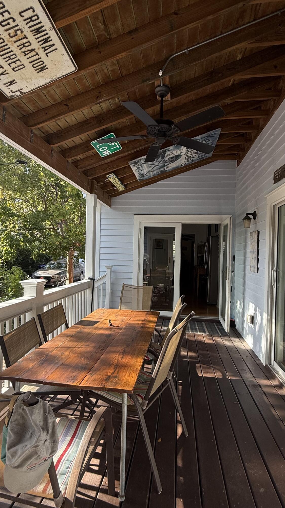 322 Southard Street Key West, FL 33040 - Photo 14 of 35 a view of a backyard with table and chairs and a wooden floor