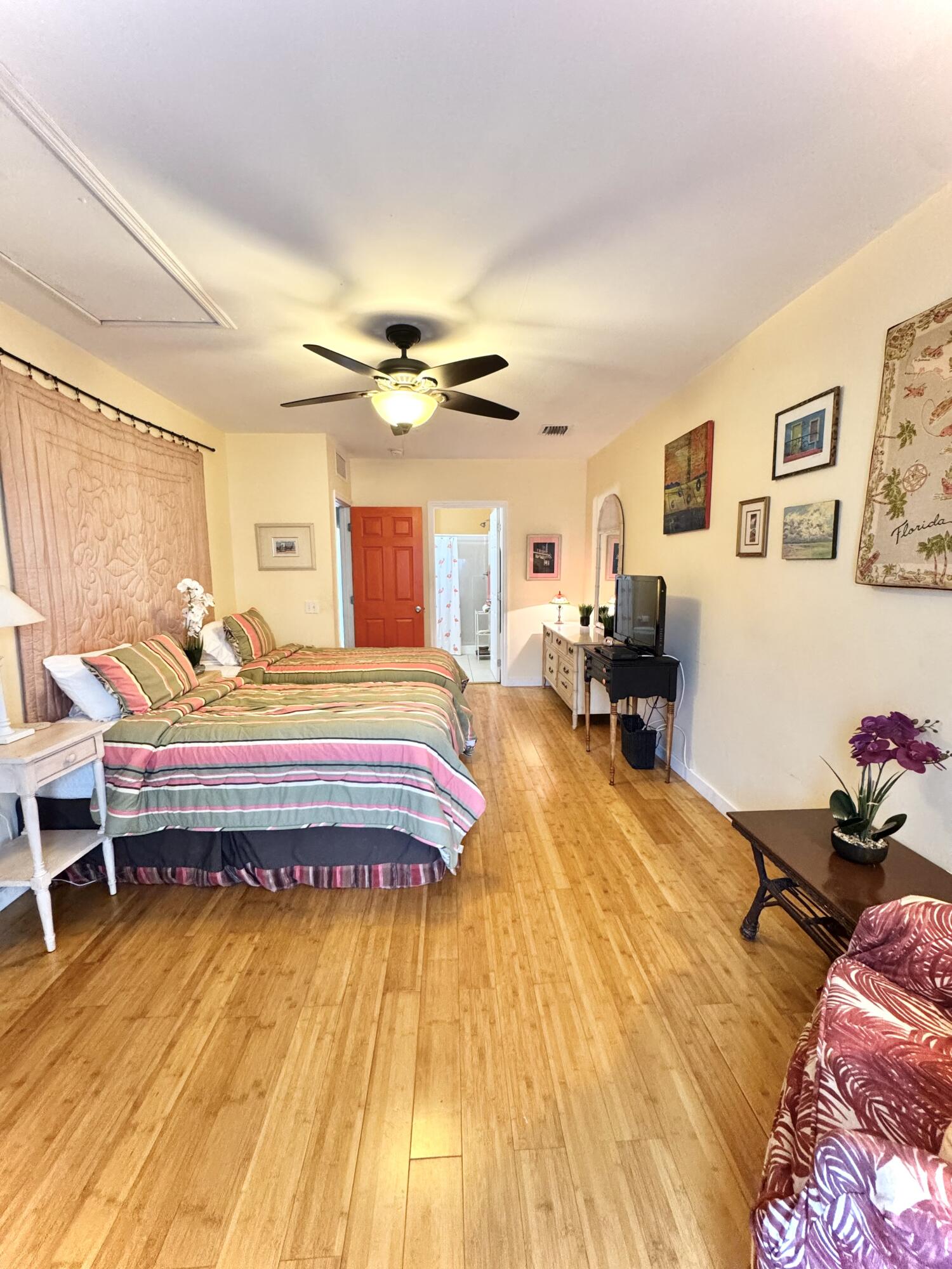 322 Southard Street Key West, FL 33040 - Photo 22 of 35 a bedroom with a bed and wooden floor
