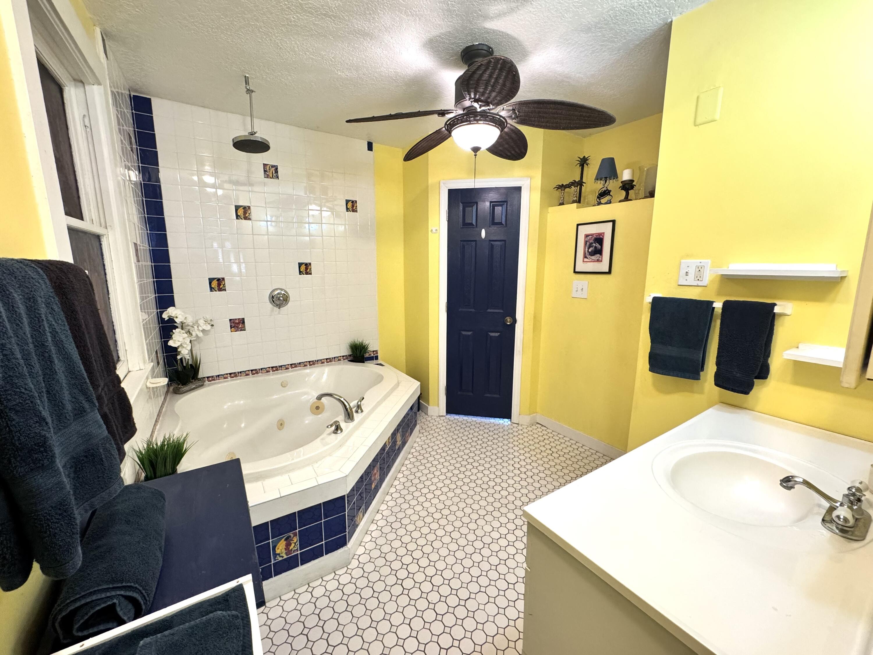 322 Southard Street Key West, FL 33040 - Photo 26 of 35 a bathroom with a tub sink and mirror