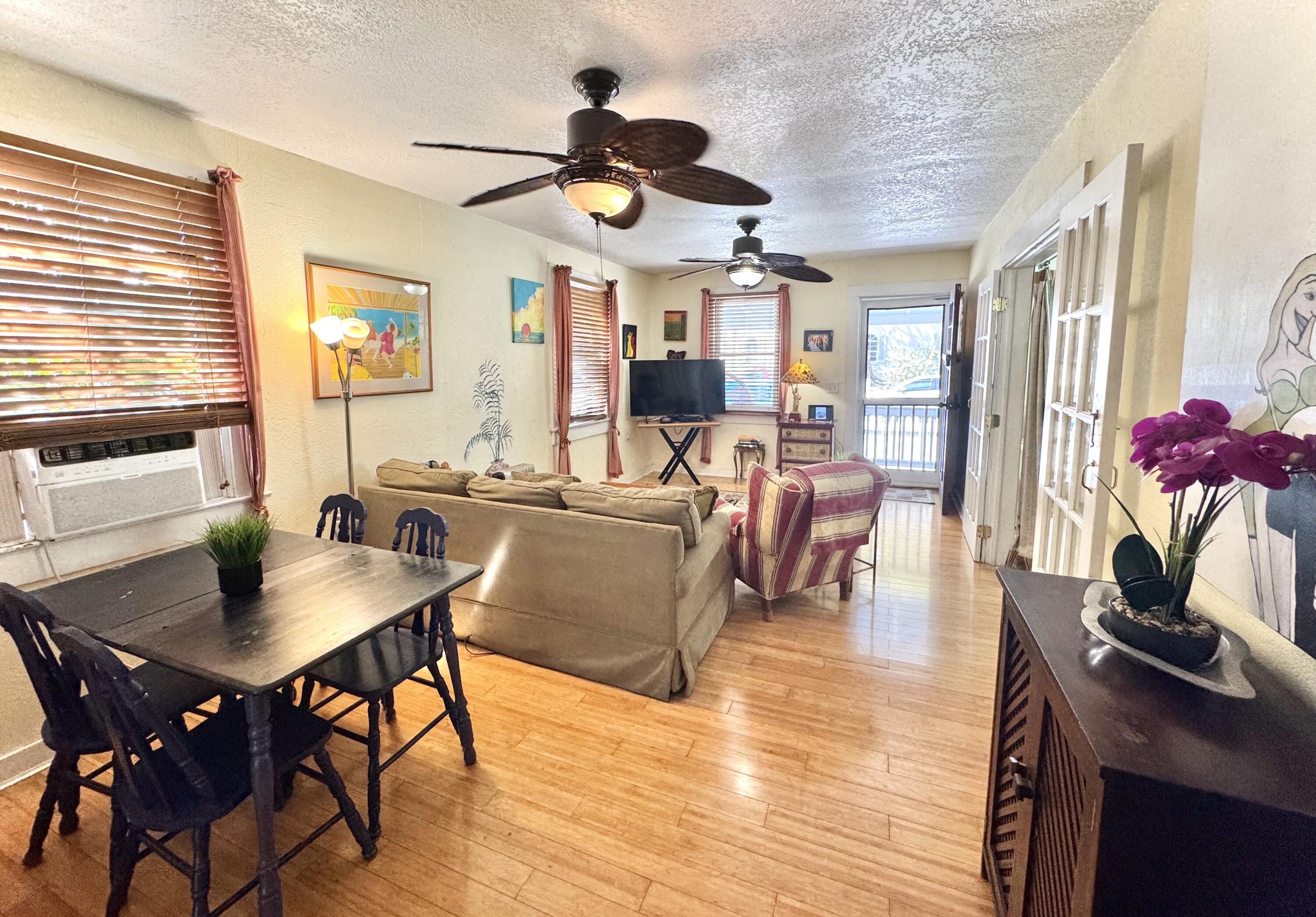 322 Southard Street Key West, FL 33040 - Photo 6 of 35 a view of a dining room with furniture window and wooden floor