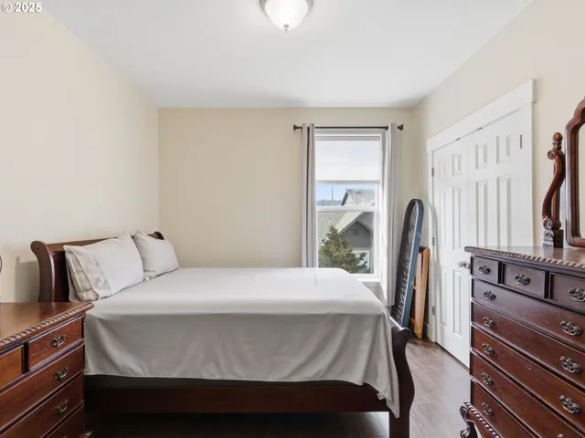 a bedroom with a bed next to a window with the outer view