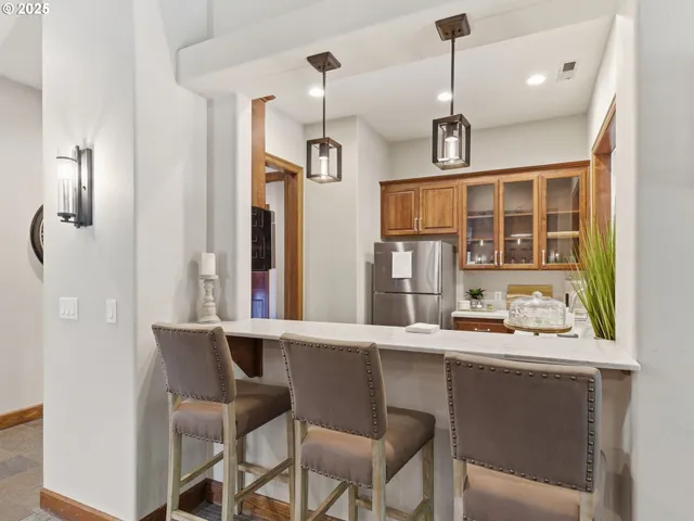 a kitchen with a dining table chairs and white cabinets