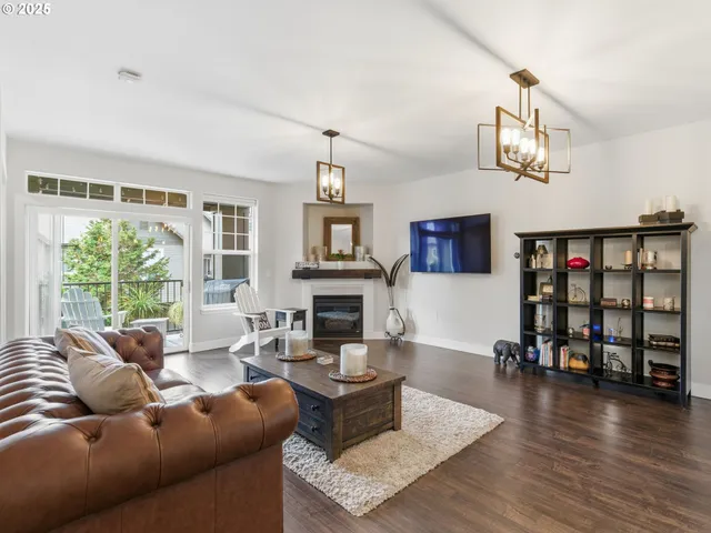 a living room with fireplace furniture and a wooden floor