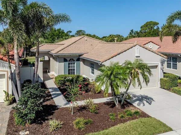 a aerial view of a house with a yard and potted plants