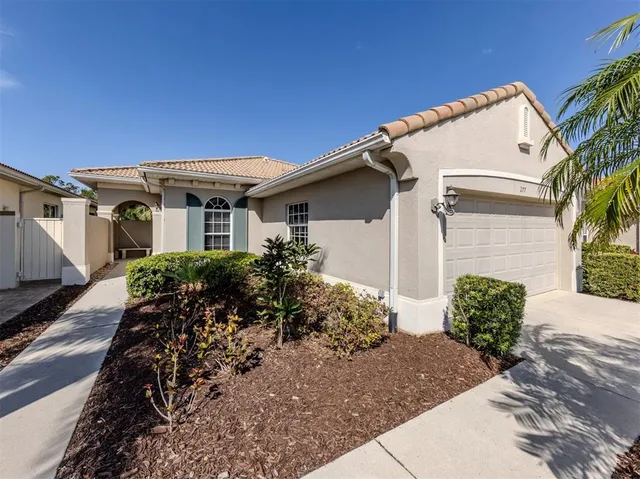 a front view of house with a garden