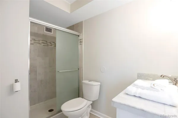 a bathroom with a toilet and shower