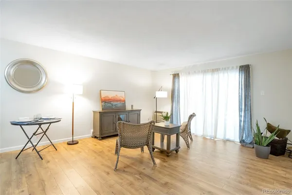 a view of a livingroom with furniture and hardwood floor
