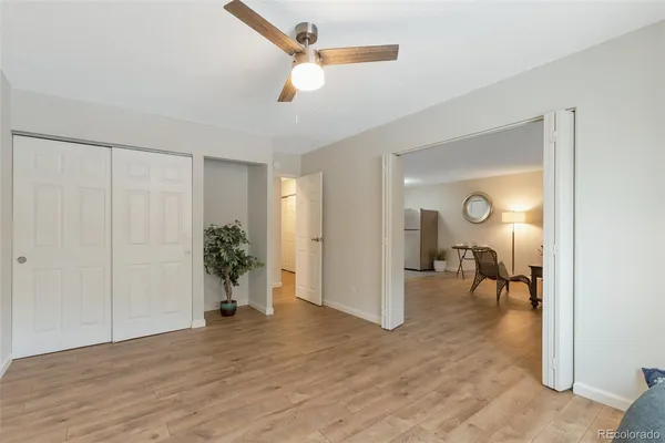 a view of a room with wooden floor table and chairs