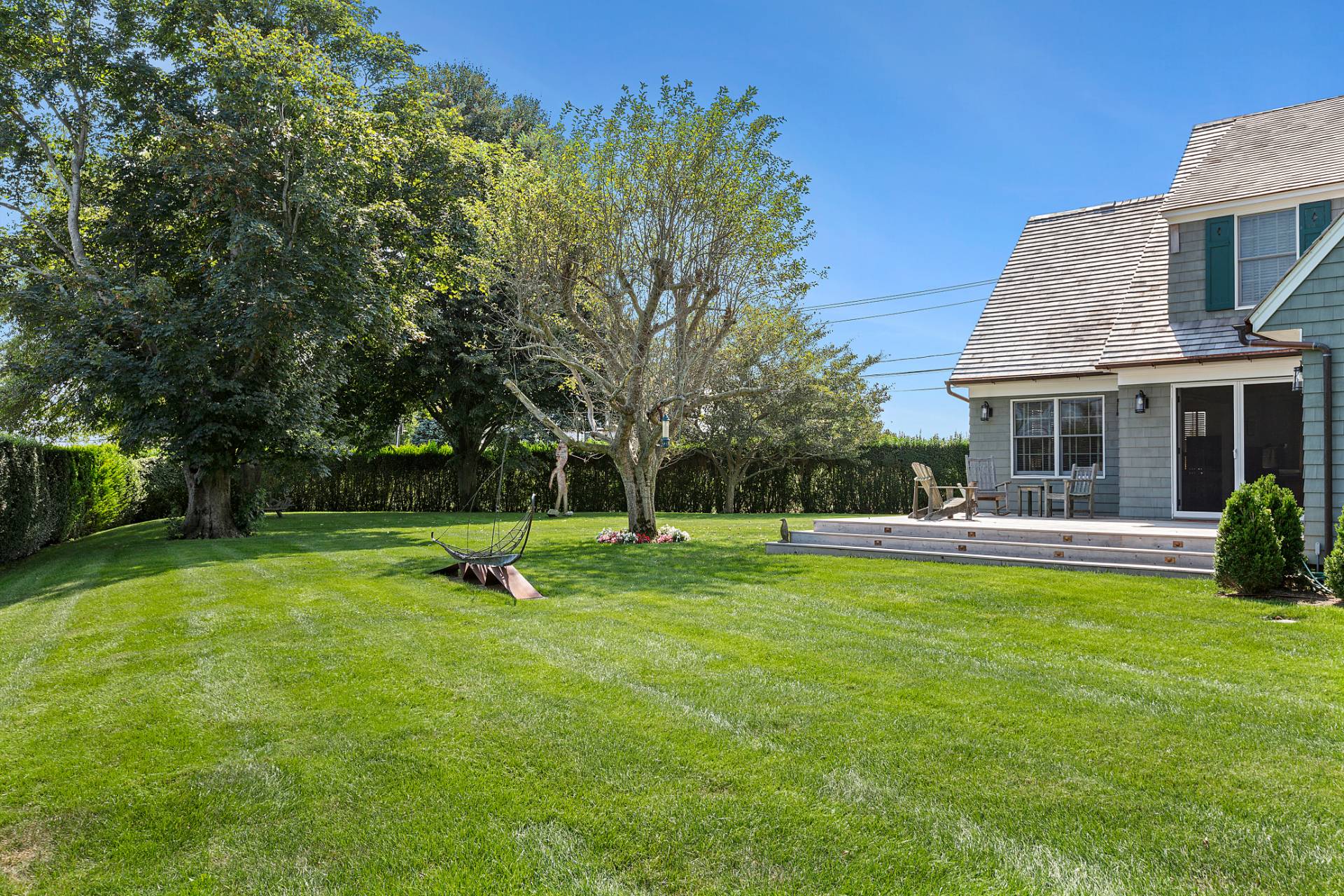 406 Hayground Road Water Mill, NY 11976 - Photo 19 of 20 a view of a house with a backyard and a patio