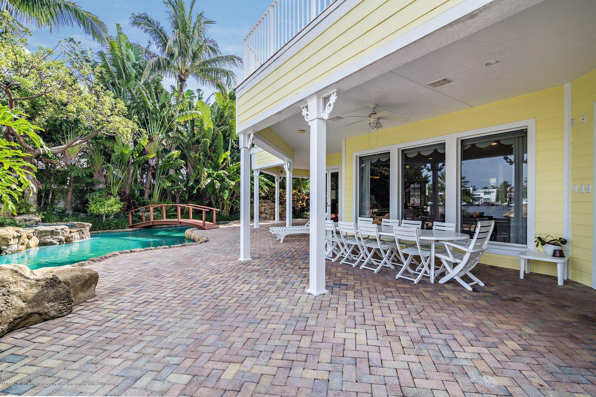 1121 Marble Way Boca Raton, FL 33432 - Photo 37 of 44 a view of a patio with a table and chairs