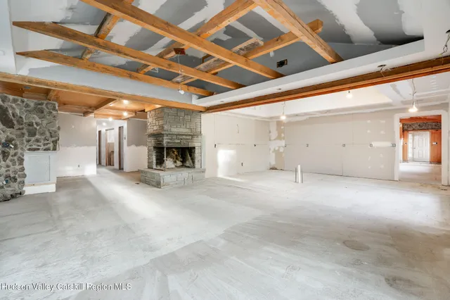 a view of a livingroom with fireplace and a furniture