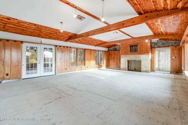 a view of an empty room with a windows and a ceiling fan