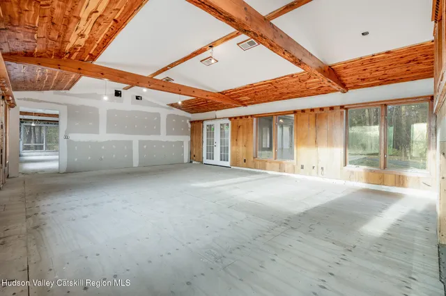 a view of an empty room with a windows and a ceiling fan