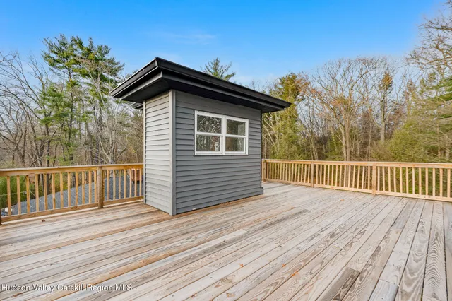 a view of a balcony with wooden floor