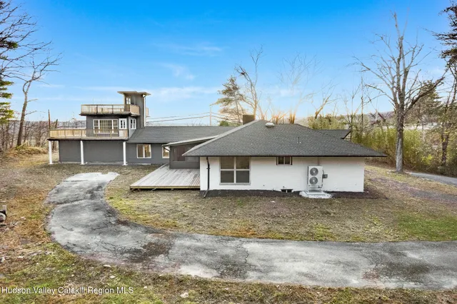 a house that has a large tree in front of it
