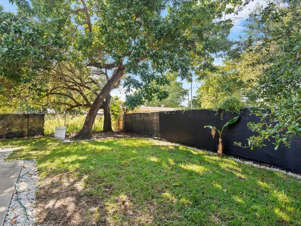 an aerial view of a house with a yard and lake view