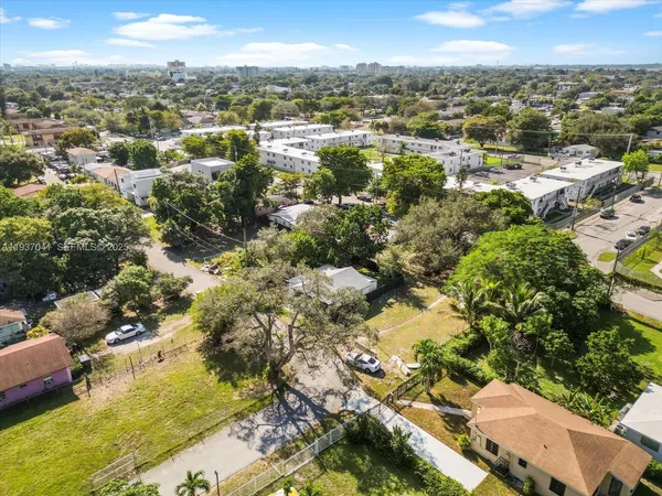 an aerial view of a house with a yard and lake view