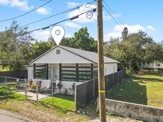 a kitchen with stainless steel appliances a sink a refrigerator and white cabinets