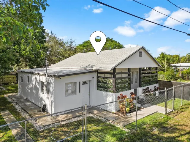 a kitchen with stainless steel appliances kitchen island a sink dishwasher a stove and white cabinets with wooden floor