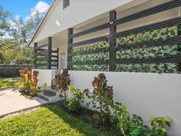 a view of a yard with a house and a tree