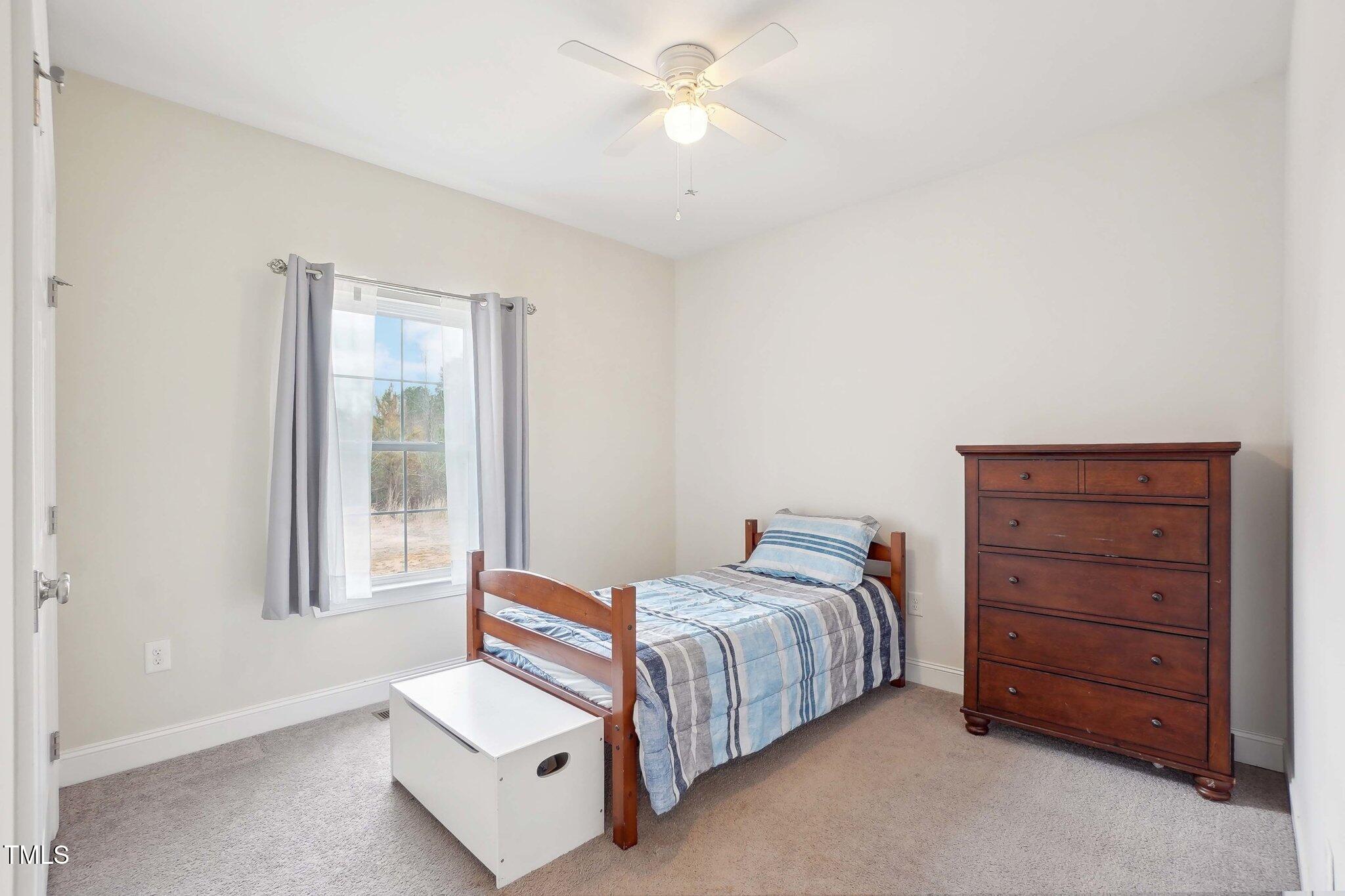7880 Flower Hill Road Middlesex, NC 27557 - Photo 24 of 45 a bedroom with a bed and a dresser