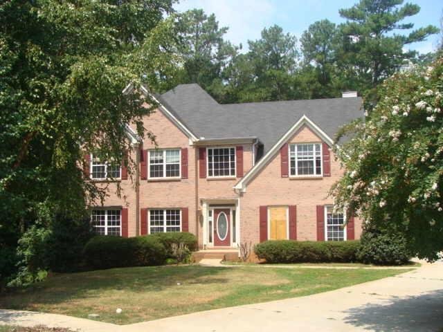 3917 Harvest Hill Road, Unit 142900 Decatur, GA 30034 - Photo 1 of 1 a front view of a house with a yard and trees