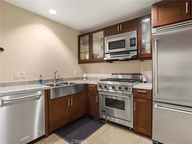a view of a patio with chairs and table under an umbrella