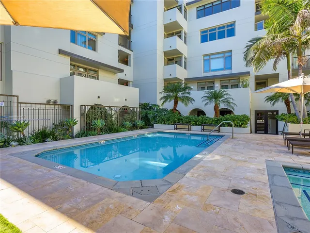a dining room with furniture and a floor to ceiling window
