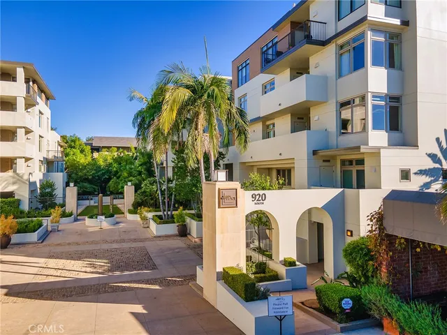 a view of a house with a garden and plants