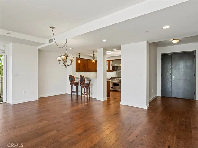 a view of a kitchen with a refrigerator microwave and wooden floor