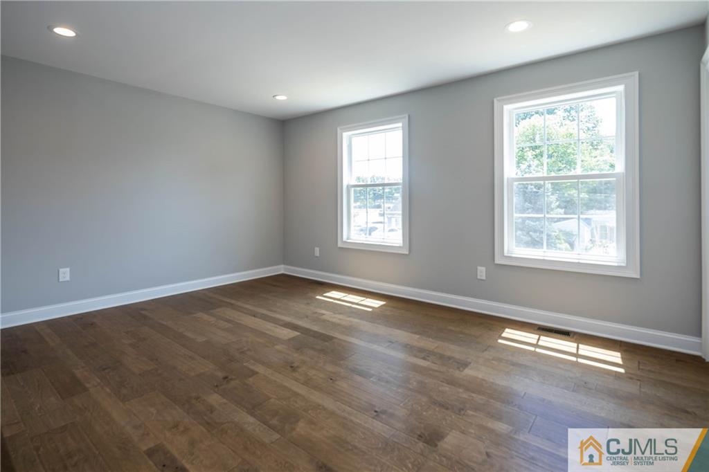48 Brookville Road Edison, NJ 08817 - Photo 23 of 28 an empty room with wooden floor and windows