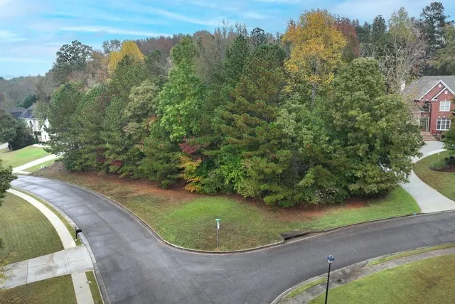 an aerial view of a house with a yard and trees