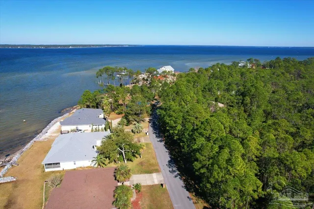 an aerial view of a houses with a yard