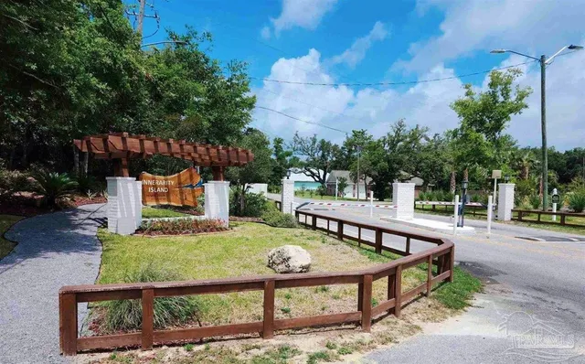 a view of a park with iron fence