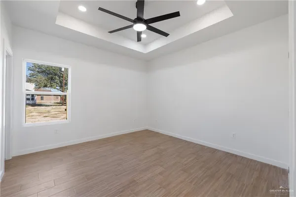 a view of an empty room with a window and closet