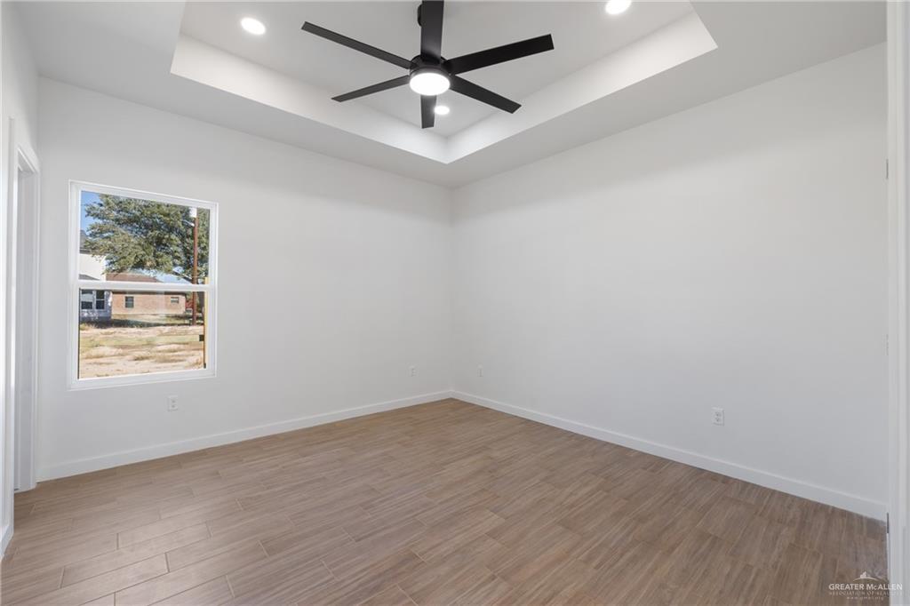 2904 Gabriel Street, Unit 3 Mission, TX 78574 - Photo 8 of 13 an empty room with a window and a fan