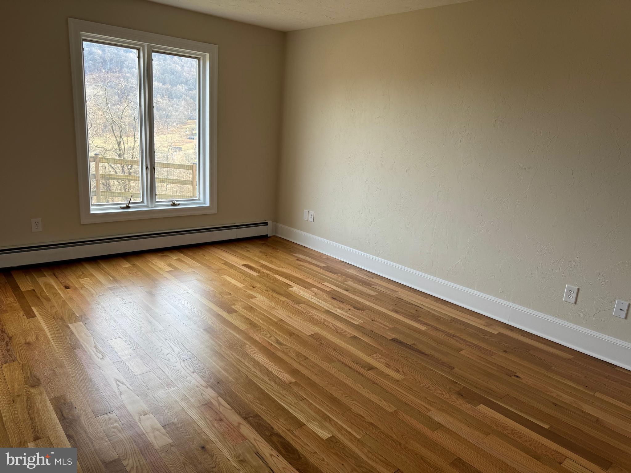 210 Raintree Lane Fairfield, PA 17320 - Photo 11 of 23 a view of an empty room with wooden floor and a window